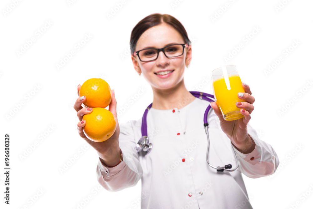Female nutritionist hold oranges and glass of fresh juice in her hands isolated on white background Female nutritionist hold oranges and glass of fresh juice in her hands isolated on white background