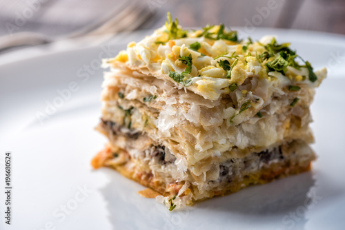 Fish pie with a dough, egg and fresh herbs photo