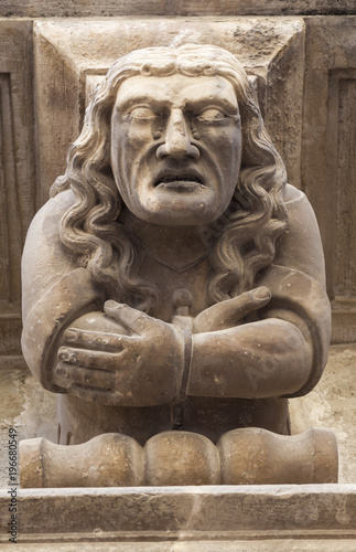 Ancient corbel, located under balconies of city hall, represent different aspects of characters medieval era, Cervera, province Lleida, Catalonia.Spain.