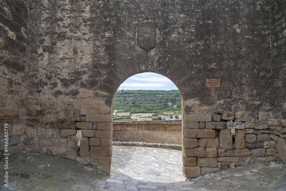 Obraz premium Ancient wall, arch entrance, medieval village of Guimera, Province Lleida, Catalonia, Spain.