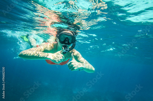 Young woman snorkel, holding two thumbs up, Similan Islands (Phang Nga), Thailand, one of the best snorkeling locations in Andaman sea.