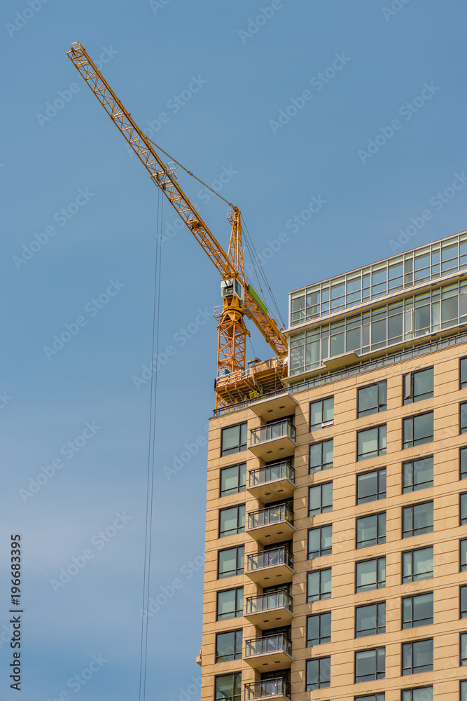 new building construction of a modern multi-storey building with a tower crane new building construction of a modern multi-storey building with a tower crane