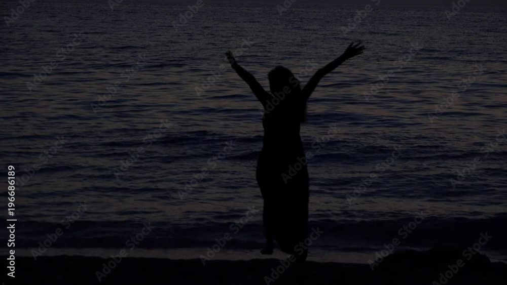 Girl silhouette running on the seashore to the sea, sundown, feeling free 4K Girl silhouette running on the seashore to the sea, sundown, feeling free 4K