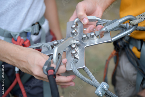 climbing gear attached to a female and male climbers harness