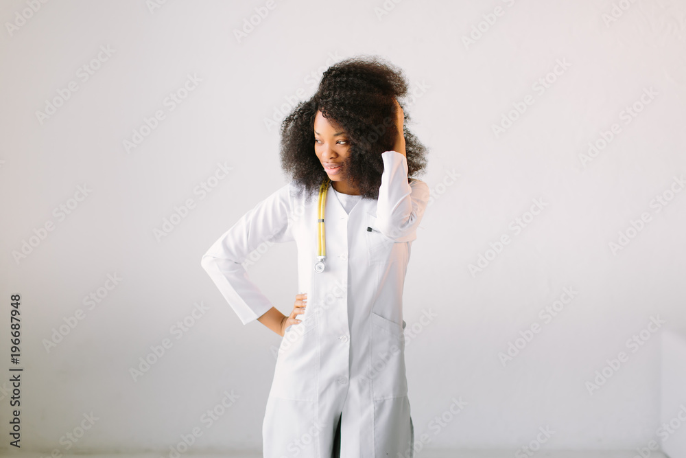 An African American female medical doctor with a stethoscope in hospital on white background An African American female medical doctor with a stethoscope in hospital on white background
