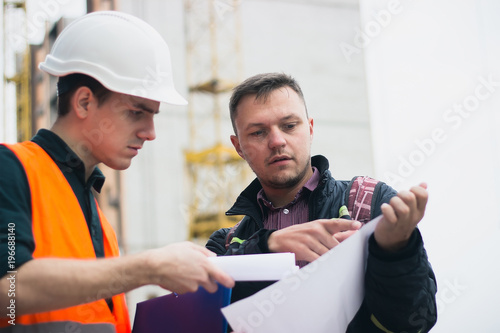 Engineering, architecture, investments, building concept. Architect and investor discuss project. photo