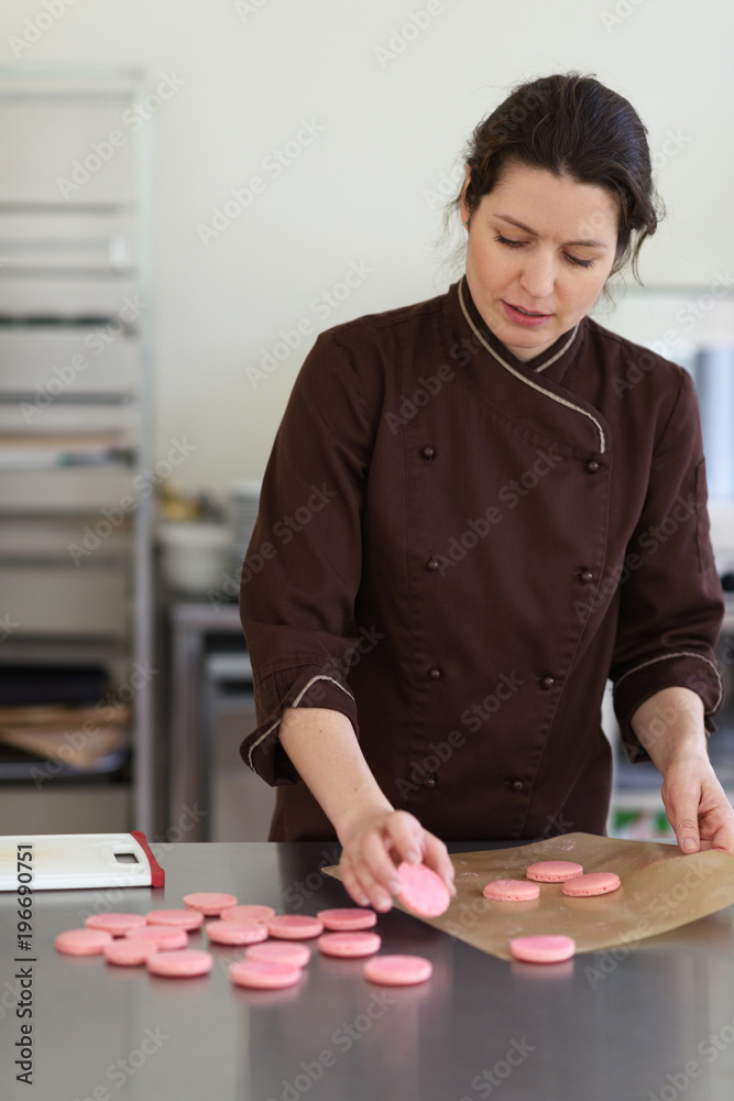 Woman preparing macaroon halves Woman preparing macaroon halves