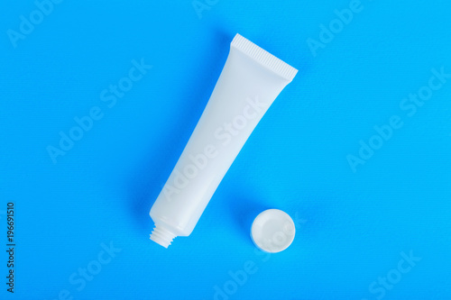 opened white cream tube with copy space