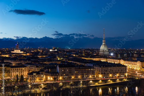 Turin skyline at dusk, Torino, Italy, panorama cityscape with the Mole Antonelliana over the city. Scenic colorful light and dramatic sky.