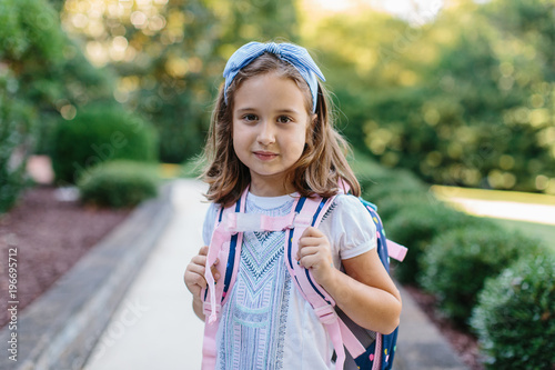 Portrait of a girl with a schoolbag ready for school