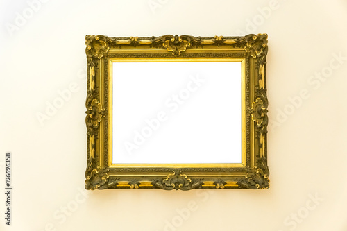 White clipped painting with a beautiful wooden carved frame hung on a clear wall.