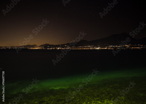 Night view of Lake Garda and the illuminated villages on the west coast.