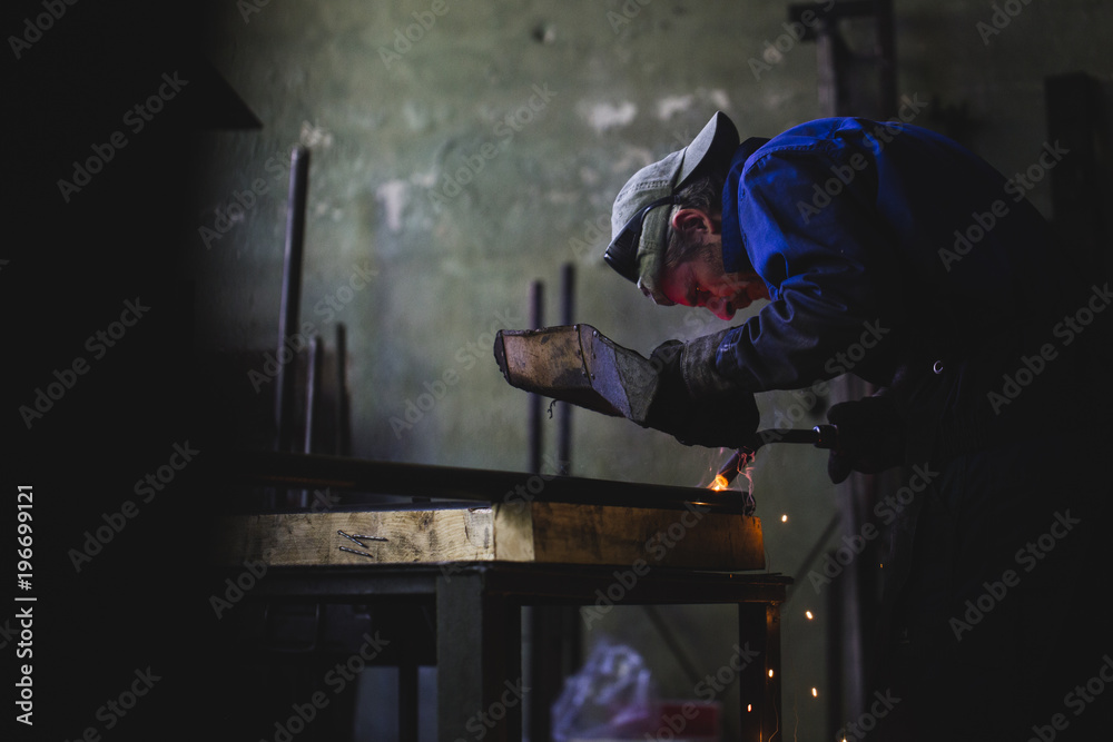 Craftsman welding in his workshop Craftsman welding in his workshop
