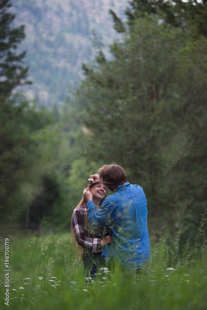 Couple enjoying romantic walk through the woods Couple enjoying romantic walk through the woods