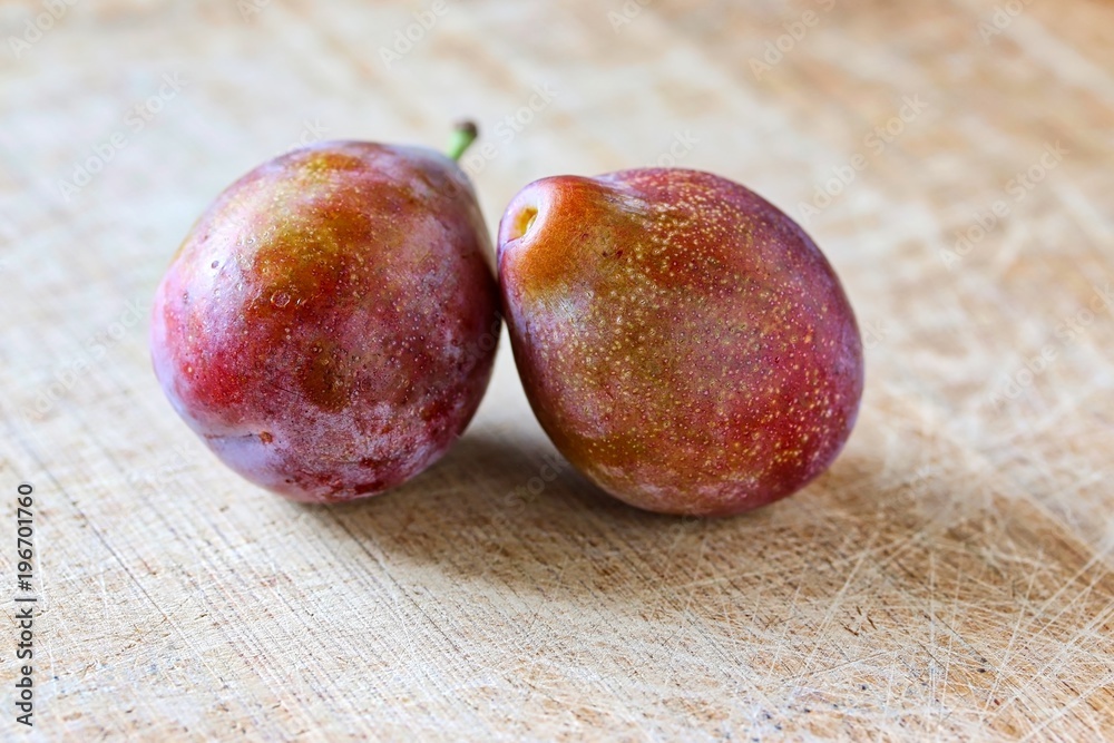 Fresh Sugar Plum On Wooden Cutting Board Fresh Sugar Plum On Wooden Cutting Board