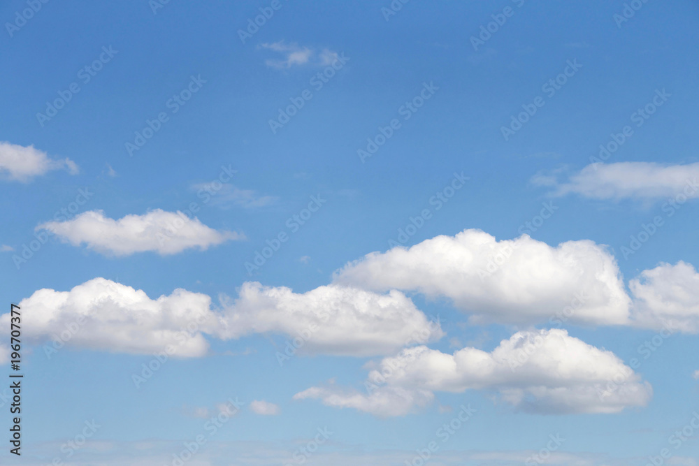 Cumulus clouds against a blue sky.