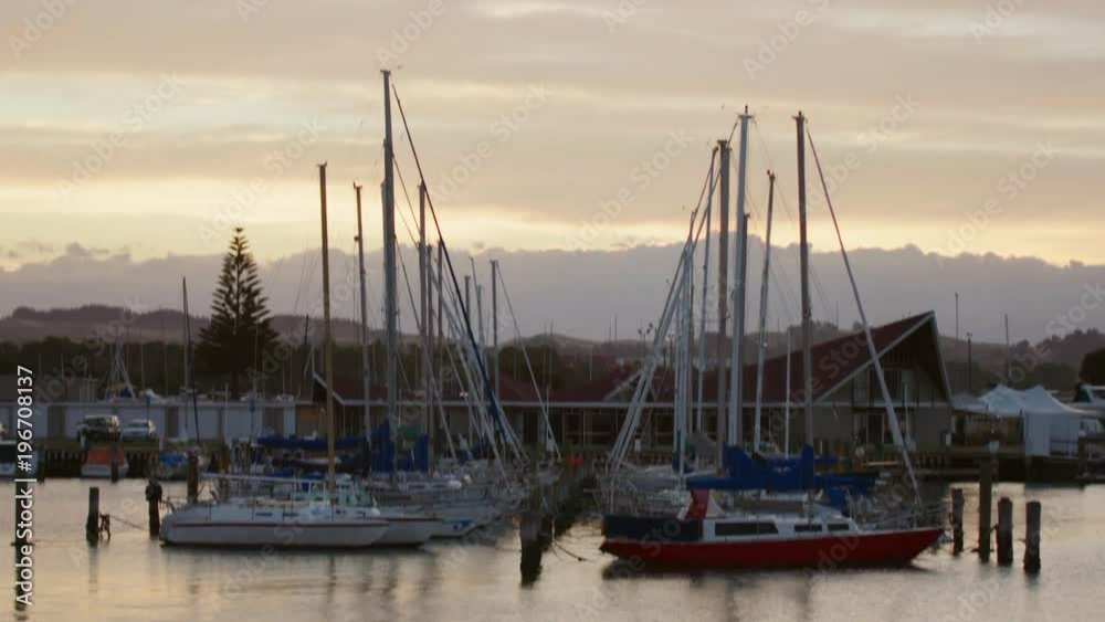 Boats in harbour at dawn with golden early morning light. Boats in harbour at dawn with golden early morning light.
