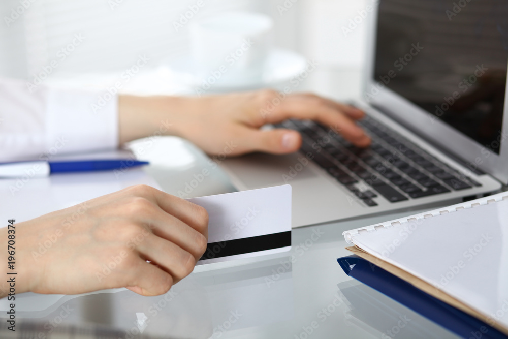 Close up of business woman hands typing on laptop computer