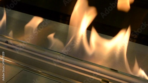 Biofireplace burn on ethanol gas. Contemporary mount biofuel on ethanol fireplot fireplace close-up. Modern ecological technologies. Interior design of a house inside photo