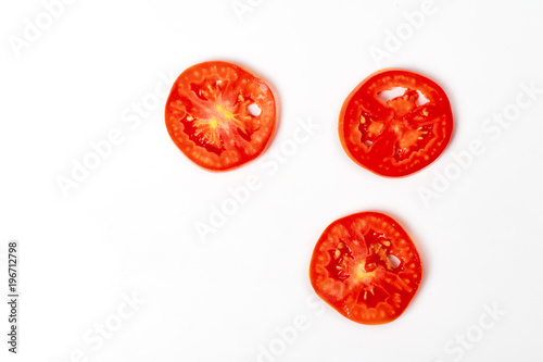 Tomato sliced tree pieces topview on white background