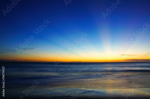 Sunset / sunrise with clouds and sea, light rays and other atmospheric effect © yaophotograph
