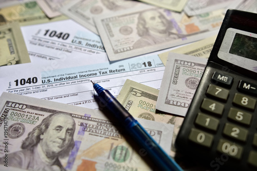 US Tax form 1040 with US dollar note.