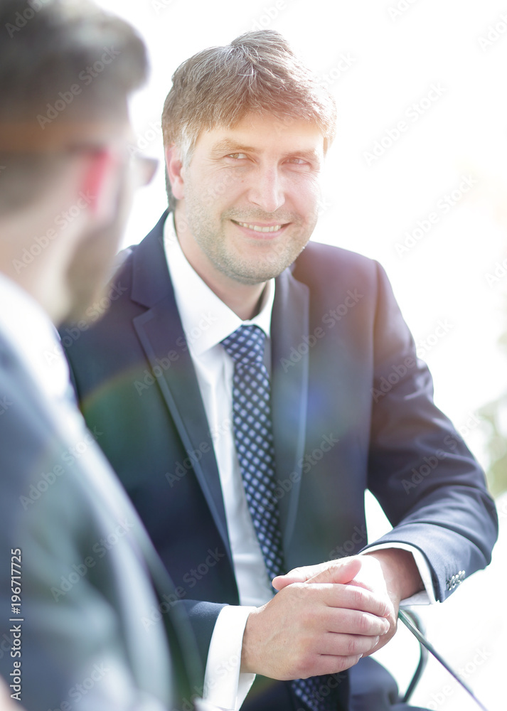 Close-up of a senior manager talking to a colleague. Close-up of a senior manager talking to a colleague.