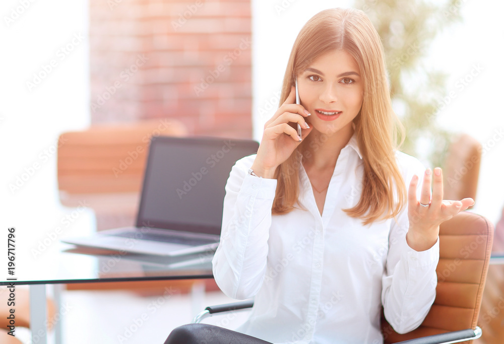 business woman talking on mobile phone sitting in the office business woman talking on mobile phone sitting in the office