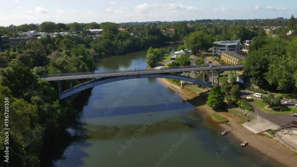 Drone shot of arching bridge on the river, Hamilton, New Zealand. Drone shot of arching bridge on the river, Hamilton, New Zealand.