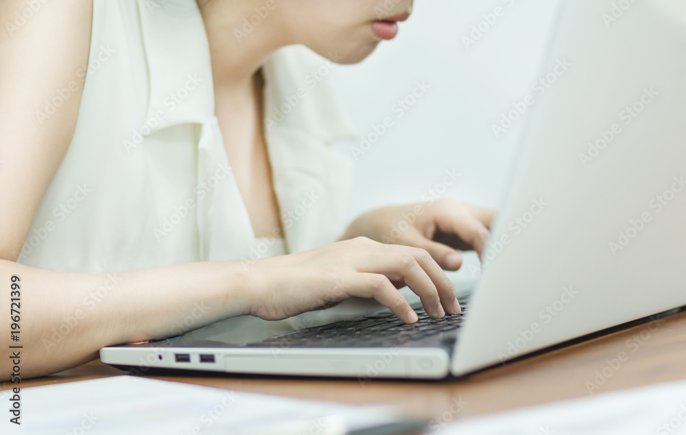 Selective focus Young business woman working on laptop in office. Selective focus Young business woman working on laptop in office.