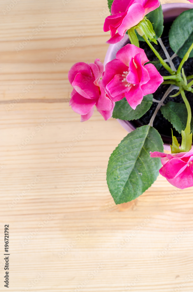 Beautiful artificial flowers on wooden background