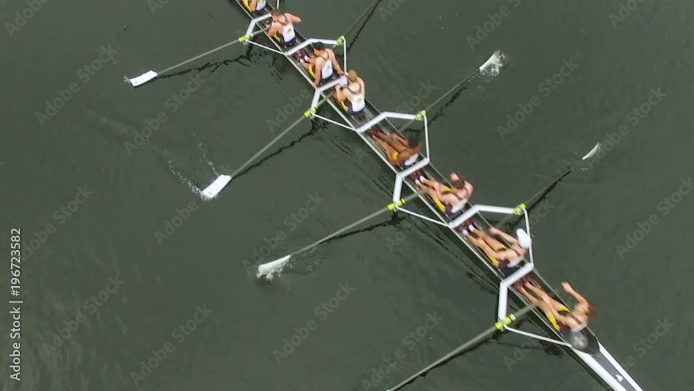 Overhead aerial of rowing team in boat rowing together