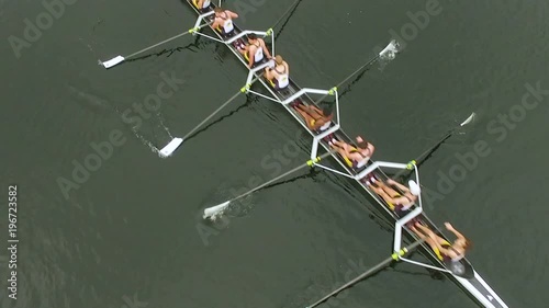 Overhead aerial of rowing team in boat rowing together