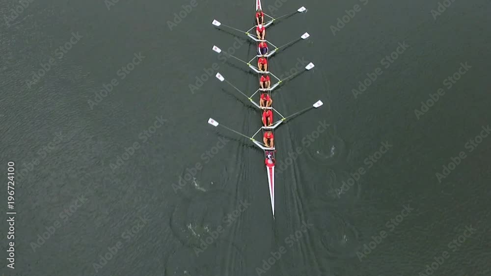 Overhead aerial of rowing team in boat rowing together
