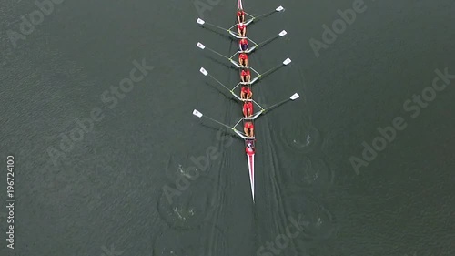 Overhead aerial of rowing team in boat rowing together photo