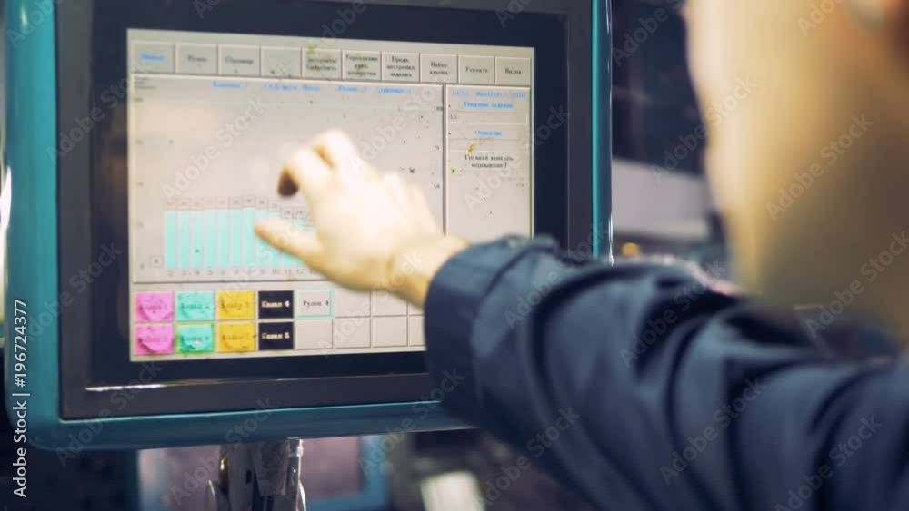 Workers hand working with computer touchscreen at industrial factory. Workers hand working with computer touchscreen at industrial factory.