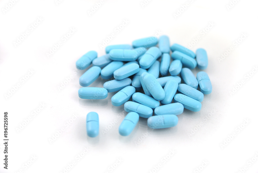 Oval blue tablets closeup on white background Oval blue tablets closeup on white background
