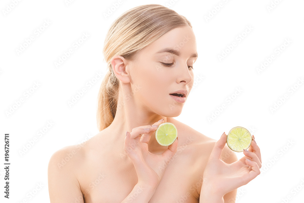 The beautiful woman holding a lime on the white background The beautiful woman holding a lime on the white background