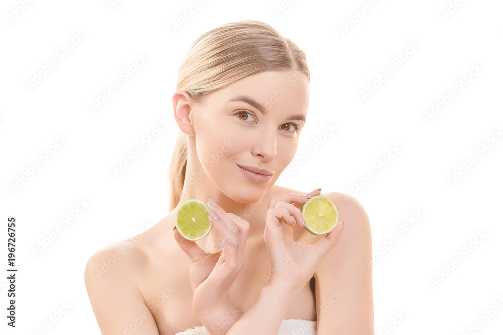 The attractive woman holding a lime on the white background The attractive woman holding a lime on the white background