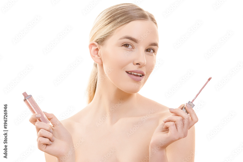 The beautiful woman holding a lip gloss on the white background The beautiful woman holding a lip gloss on the white background