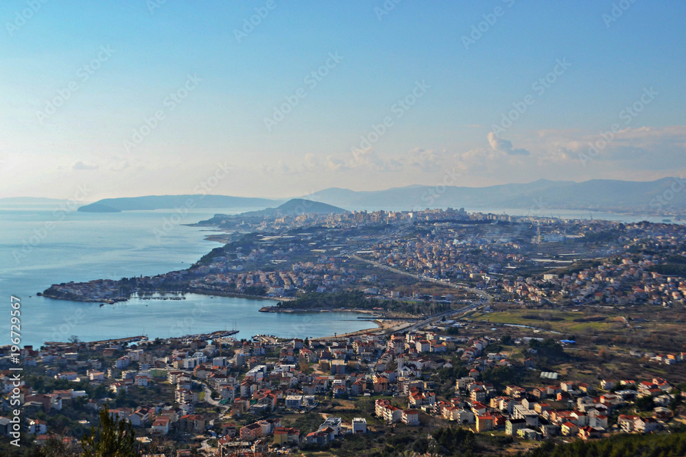 Aerial view from the top at the city, sky and sea as background 