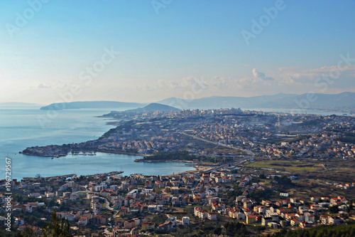 Aerial view from the top at the city, sky and sea as background  © Sanja