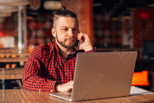 Modern hipster businessman using mobile phone. Phone conversation.