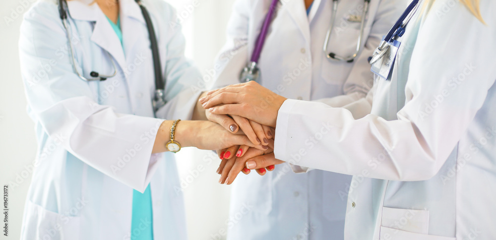 Doctors and nurses in a medical team stacking hands Doctors and nurses in a medical team stacking hands