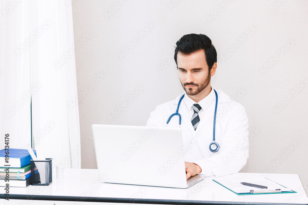 Doctor and stethoscope working with laptop computer in hospital.healthcare and medicine Doctor and stethoscope working with laptop computer in hospital.healthcare and medicine