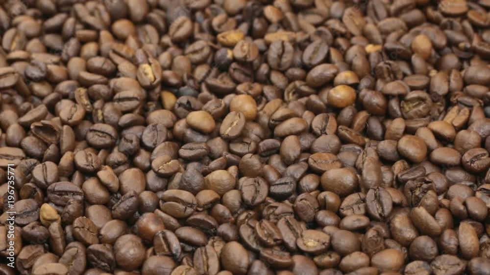 Rotation, background made from a pile of coffee beans. Rotation, background made from a pile of coffee beans.