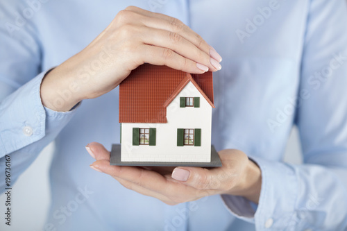 woman holding model of the house