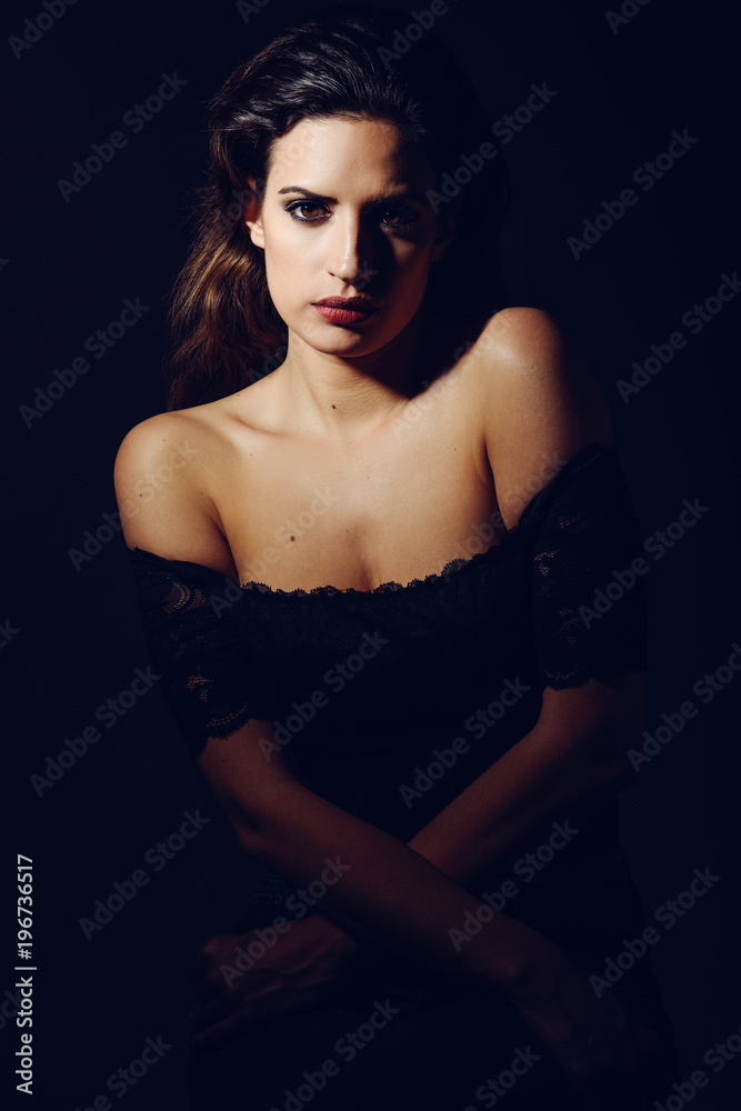 Young brunette woman in black lingerie in chiaroscuro lighting Young brunette woman in black lingerie in chiaroscuro lighting