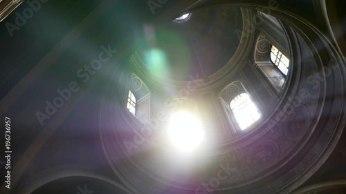 Sun light passes through the stained glass windows of the church