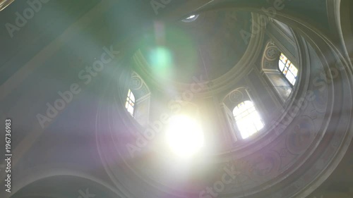 Sun light passes through the stained glass windows of the church